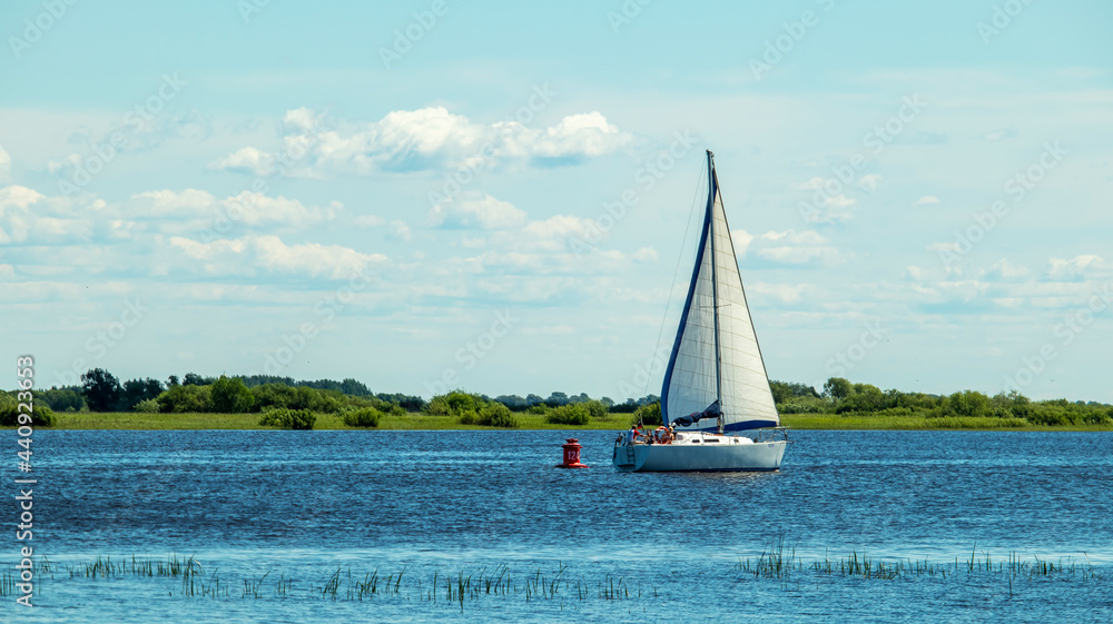 Obraz premium a large white yacht floats upstream on a sunny day