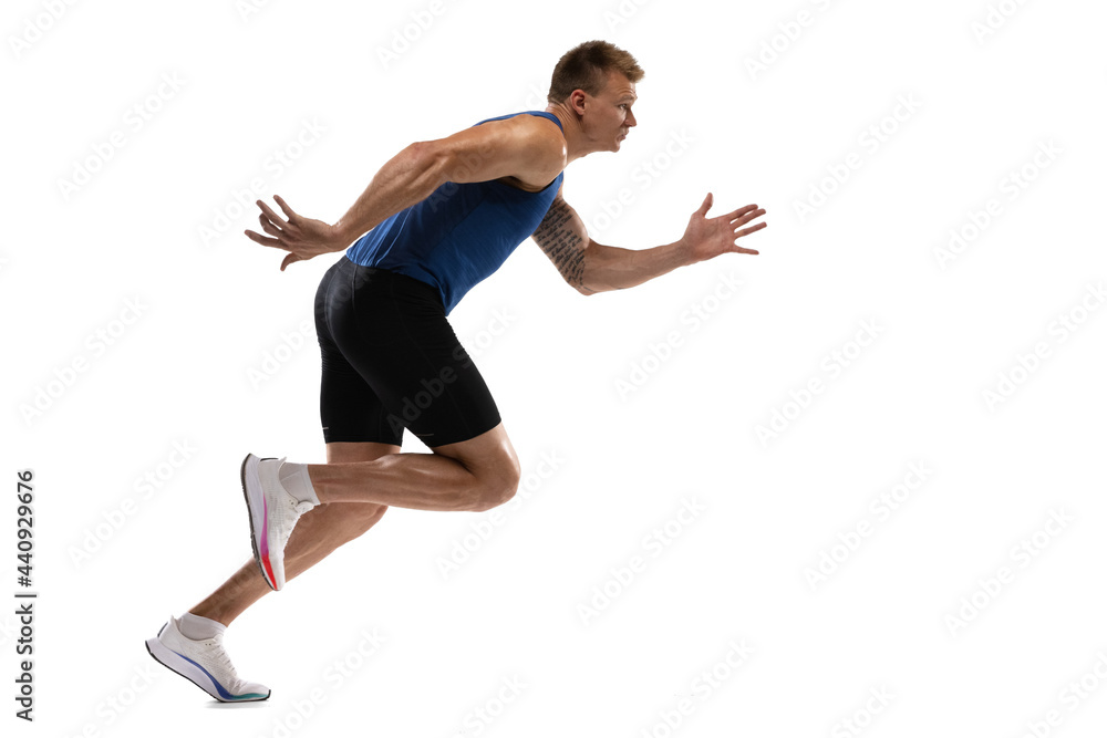 Caucasian professional male athlete, runner training isolated on white studio background. Muscular, sportive man.