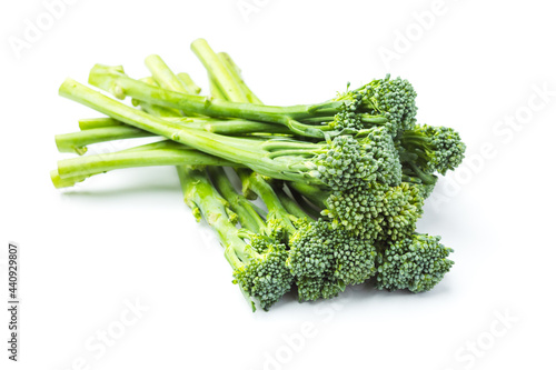 Raw broccolini heap isolated on white background photo