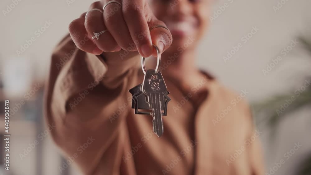 Close up of dark skinned female tenant renter show praise house keys
