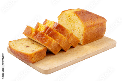 Tableau sur toile Sliced pound cake with lemon glaze on a cutting board isolated on a white background