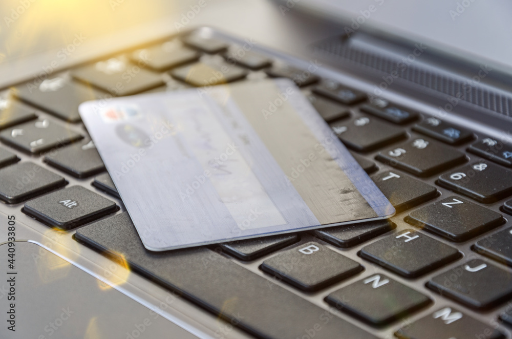 Credit card on computer keyboard symbolising online banking or shopping Credit card on computer keyboard symbolising online banking or shopping