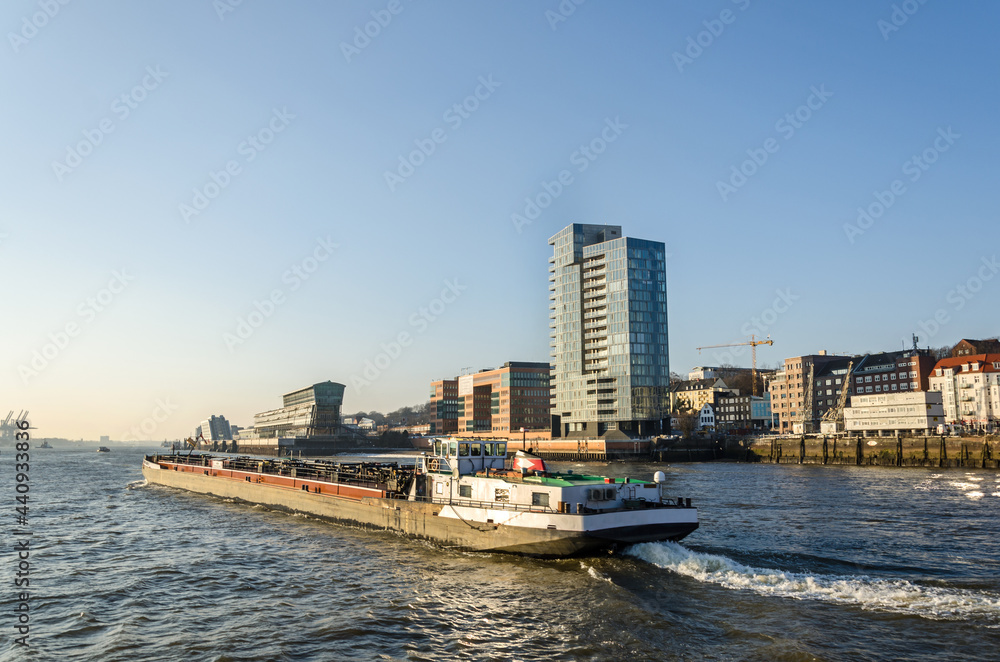 Scenic waterfront and industrial boat on the Elbe river in Hamburg, Germany Scenic waterfront and industrial boat on the Elbe river in Hamburg, Germany