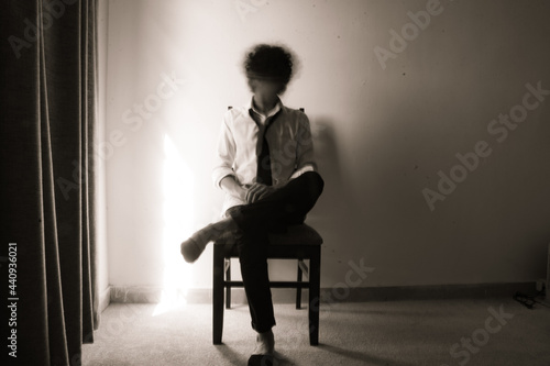 Depressed person sitting on chair . long exposure 