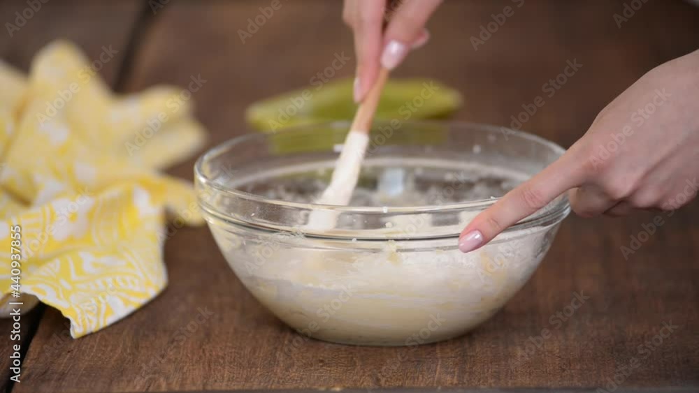 Hands Mixing Batter with a Spatula in a Glass Bowl Hands Mixing Batter with a Spatula in a Glass Bowl