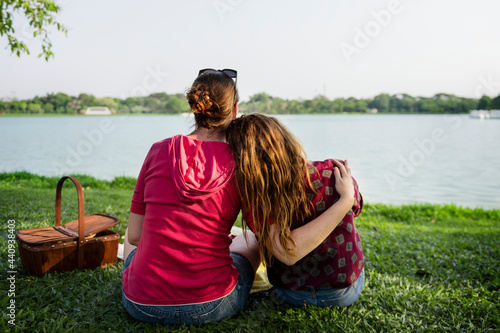 Mother and daughter having a picninc in the park photo