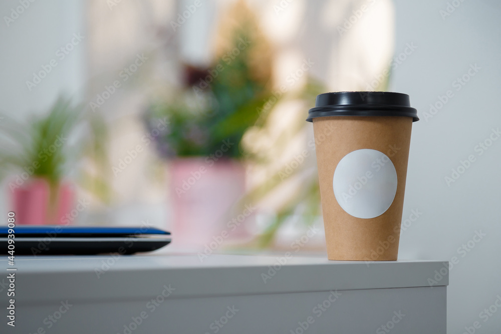 Disposable paper cup of coffee with white mock up label standing on ...