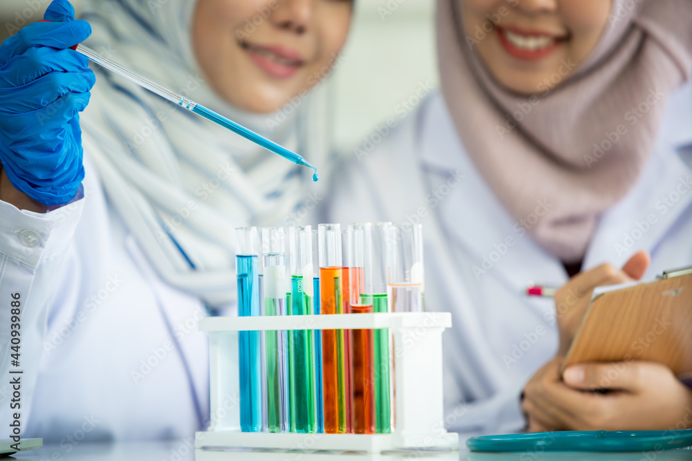 Asian young Muslim scientist testing the chemical experiment in laboratory. Asian young Muslim scientist testing the chemical experiment in laboratory.