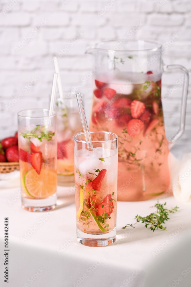 Strawberry summer cocktail or lemonade with thyme and lemon. Cold refreshing organic soft drink with ripe berries in a glass Strawberry summer cocktail or lemonade with thyme and lemon. Cold refreshing organic soft drink with ripe berries in a glass