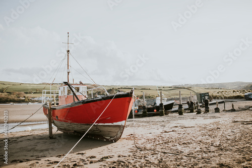 Sailboat stranded on a beach during ebb  Wales  UK