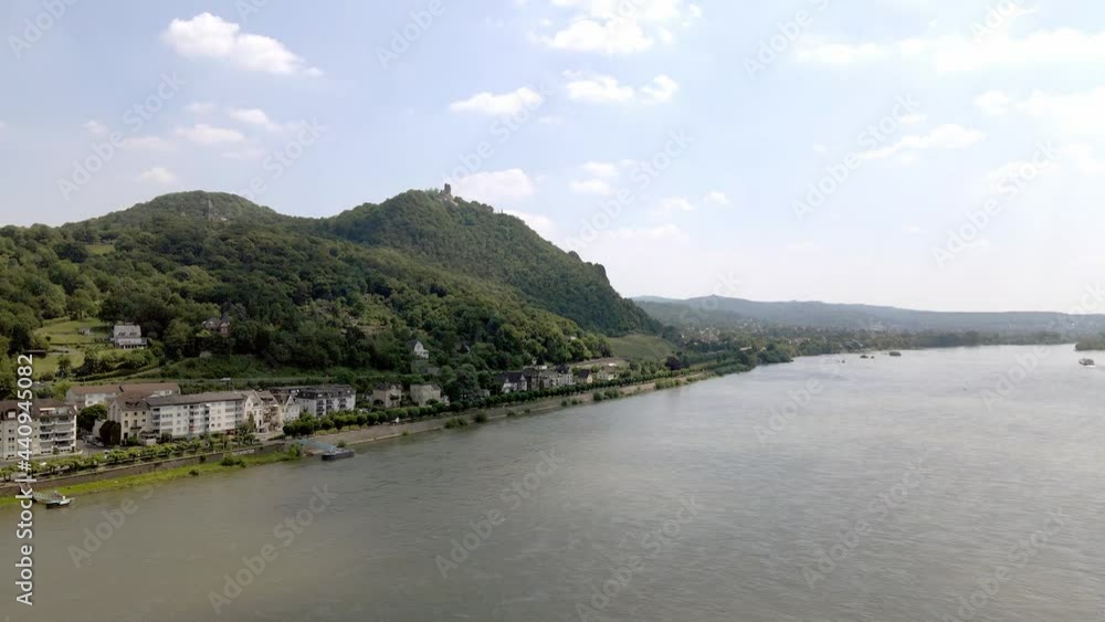 Town next to river with traffic in daytime panoramic drone shot Town next to river with traffic in daytime panoramic drone shot