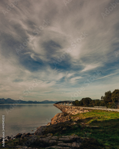 Road and a mountain range under a complex and detailed sky