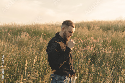 man in the field smoking cigar © Eugene