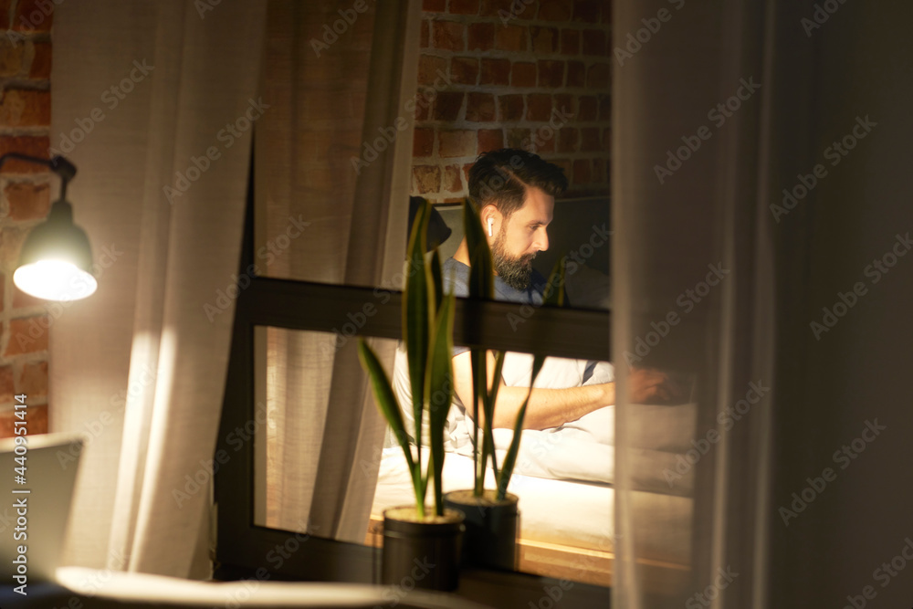 Man working at night reflected in the window Man working at night reflected in the window