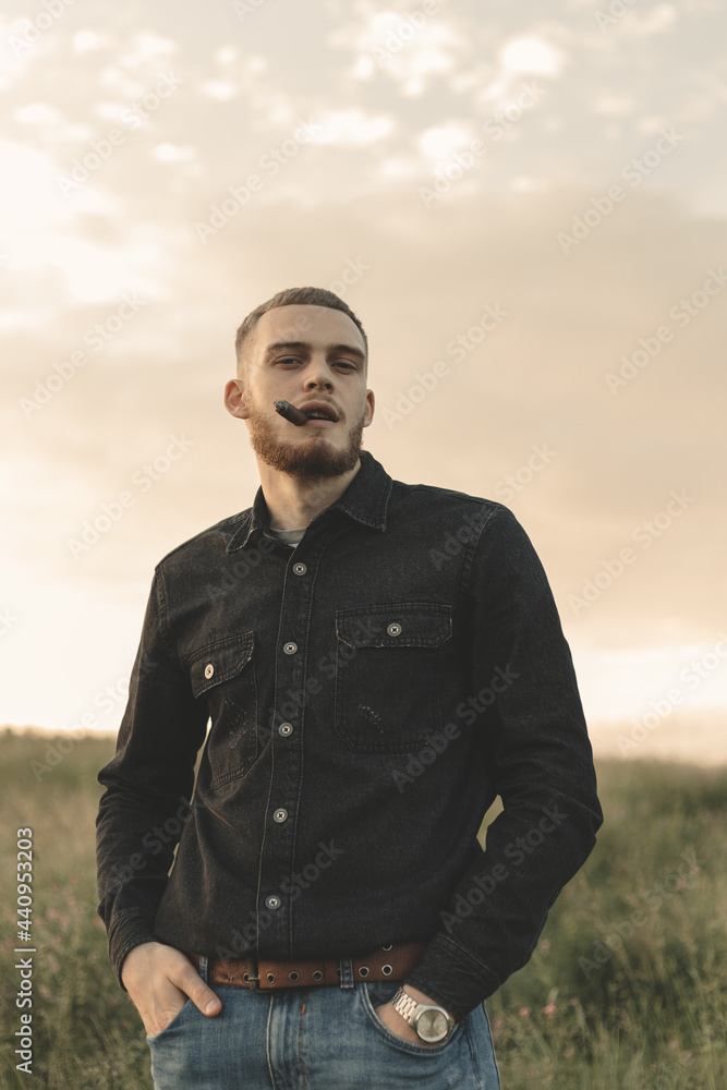 man in the field smoking cigar man in the field smoking cigar
