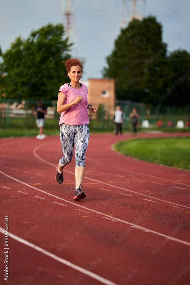 Woman running on track Woman running on track