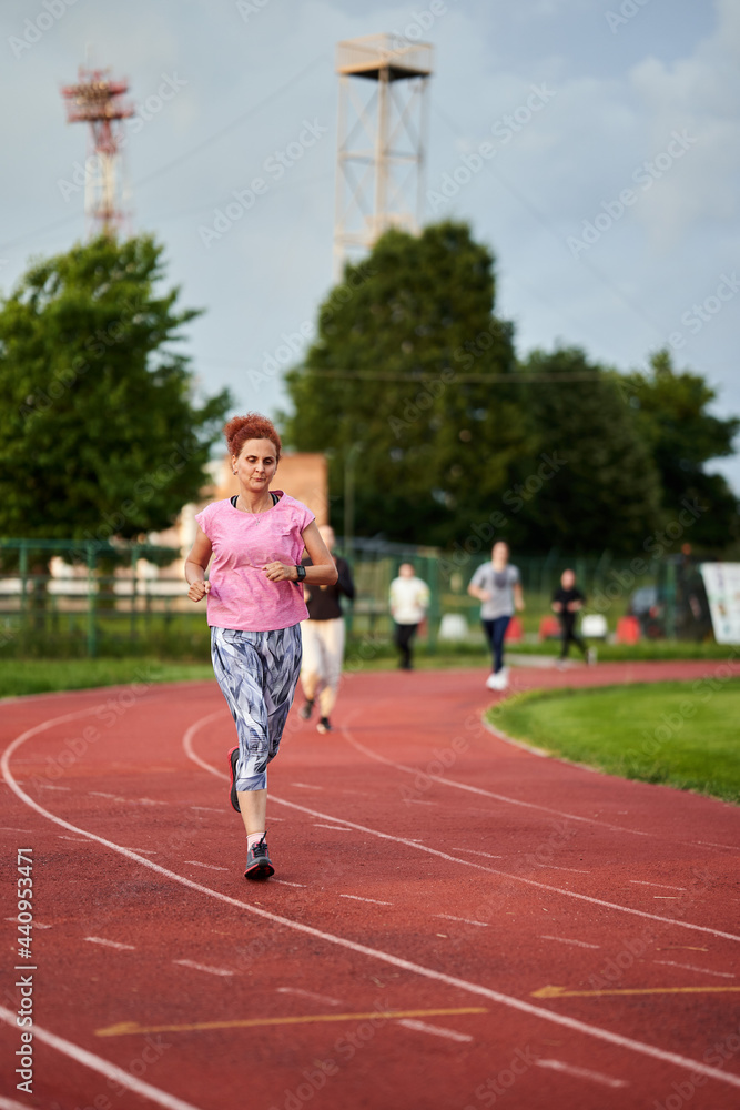 Fototapeta premium Woman running on track