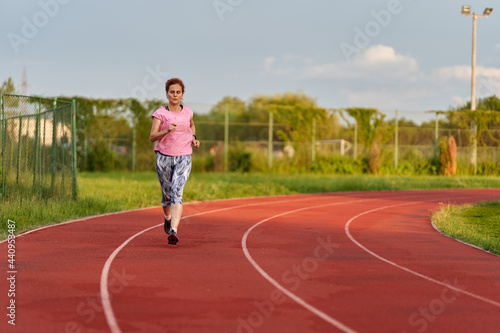 Woman running on track