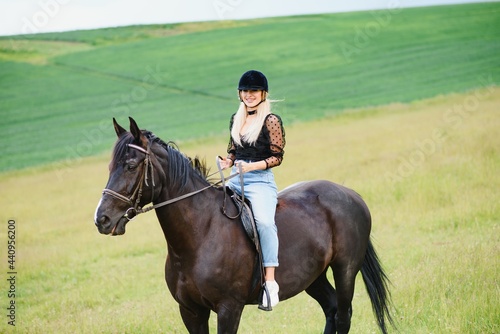 Beautiful girl riding a horse in countryside.
