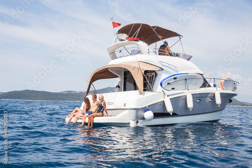 Obraz na płótnie group of young people enjoying a yacht at holiday in the sea w salonie