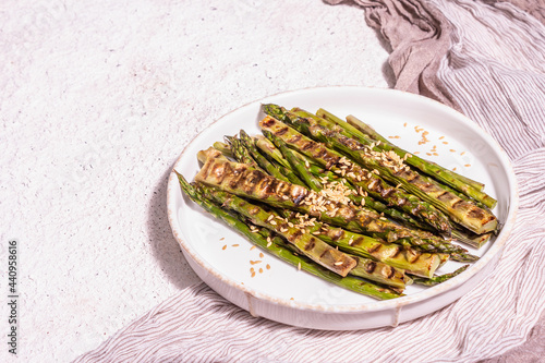 Ripe grilled asparagus. Sauce, golden flax seeds, healthy and wholesome food concept