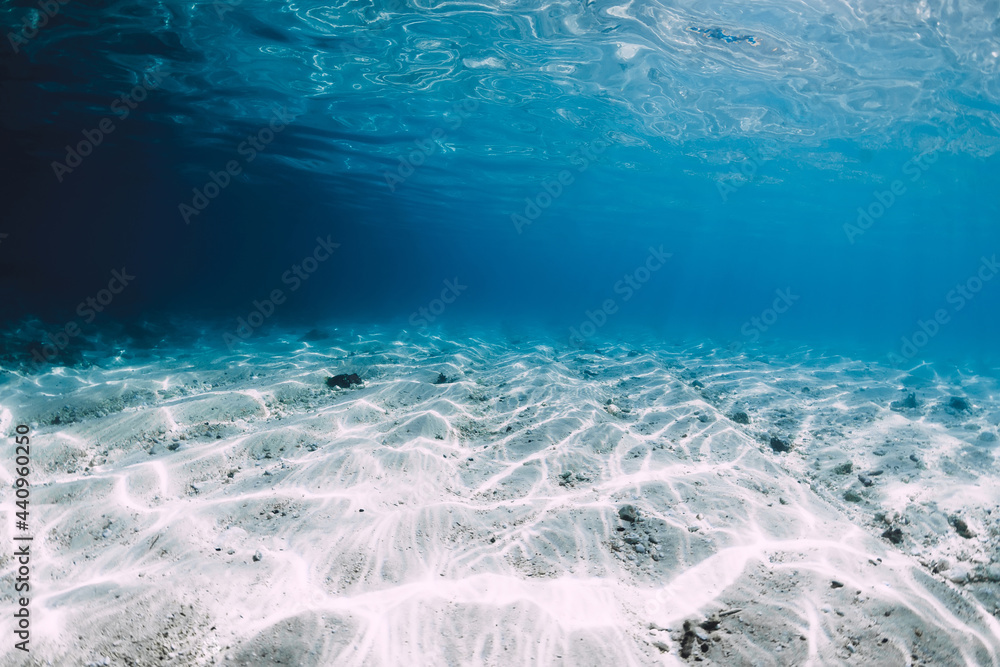 Transparent blue ocean with white sand underwater in Hawaii