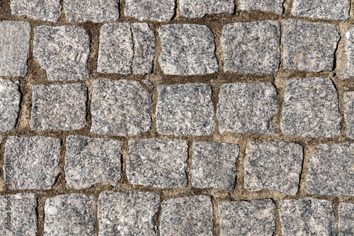 Grey stone background. Ancient stone pavement.