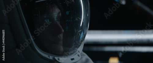 Portrait of Caucasian female astronaut inside spaceship cockpit. Sci-fi space exploration concept. Moon mission. Shot with 2x Anamorphic lens photo