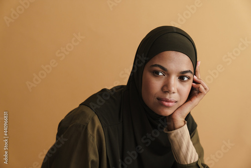 Black muslim woman in hijab posing and looking aside photo