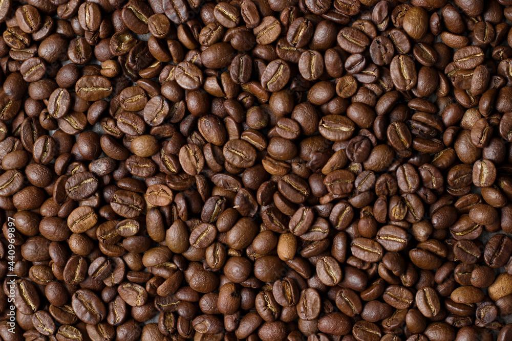 Light roasted coffee beans Poured from the hands and from the glass Taken on a black background Light roasted coffee beans Poured from the hands and from the glass Taken on a black background