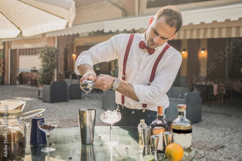 Barman is making a cocktail outdoor
