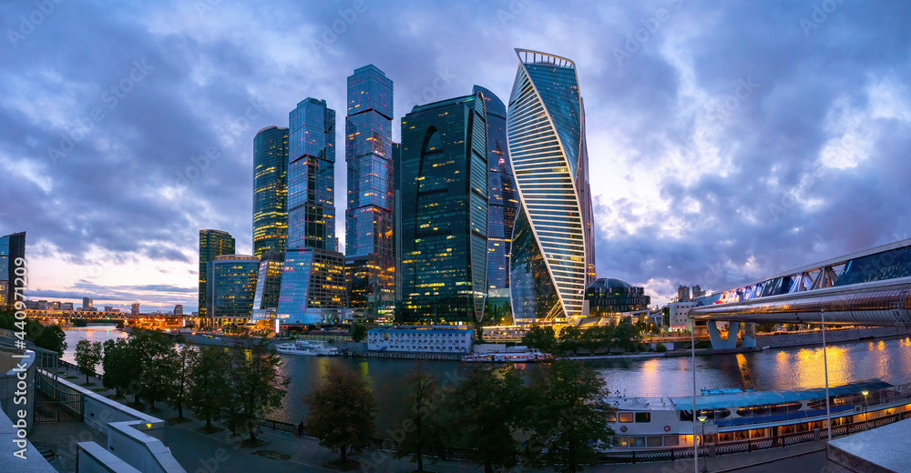Obraz premium City landscape of Moscow. Skyscrapers in Russia. Business district of Moscow. Skyscrapers of Moscow on summer evening. Moskva-city with burning lights. Panorama Russia with skyscrapers.