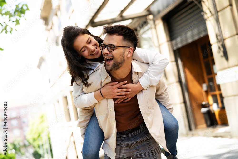 Happy young couple outdoors. Loving couple walking in the city.