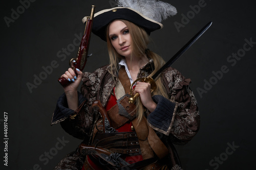 Woman buccaneer dressed in pirate suit and hat