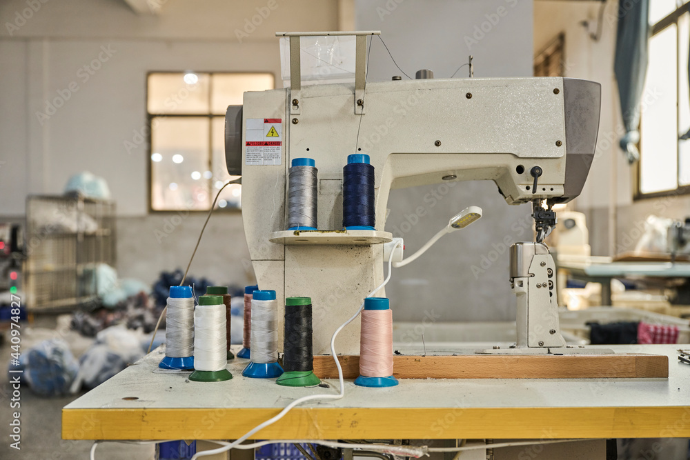 Detail of yarn packages in sewing machine at Chinese shoes factory Detail of yarn packages in sewing machine at Chinese shoes factory