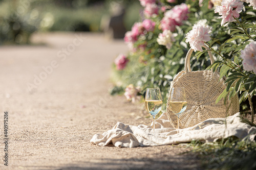 Fototapeta Naklejka Na Ścianę i Meble -  Romantic picnic on the lawn with peonies.
