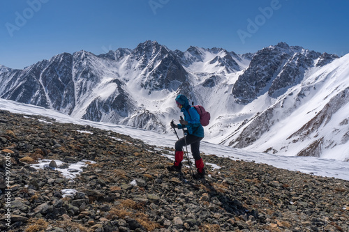 Girl with a backpack climbs the mountain © tilpich