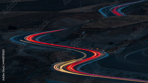 Car lights at night on the mountain pass winding road