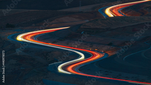 Car lights at night on the mountain pass winding road 