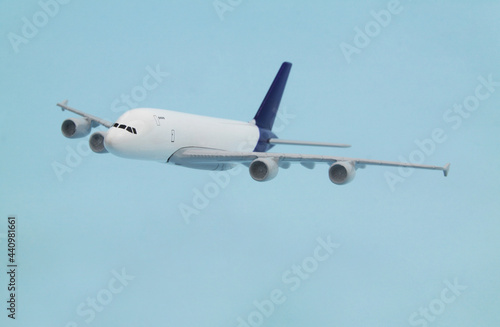 Airplane model on blue background. Travel and transportation concept.  
