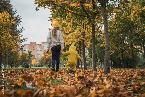 Happy children walk in autumn park. leaf fall, lifestyle © irishasel