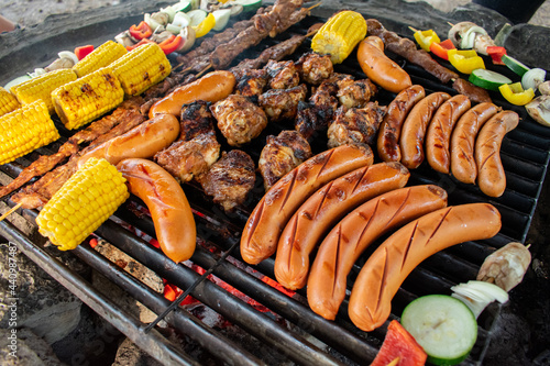 Sausage, Meat and Vegetable Barbecue. Home-marinated and home-prepared pork, chicken, and vegetable barbecue. No grilling is complete without a sausage. Plus with some corn, everything is perfect.