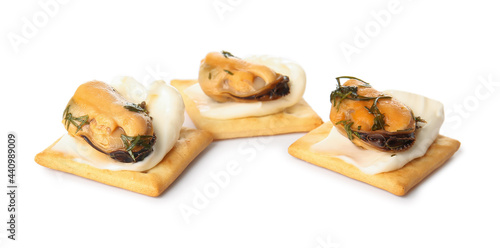 Tasty crackers with cheese and mussels on white background