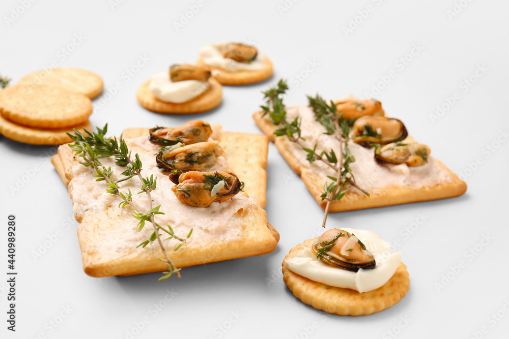 Tasty crackers with mussels and thyme on grey background, closeup