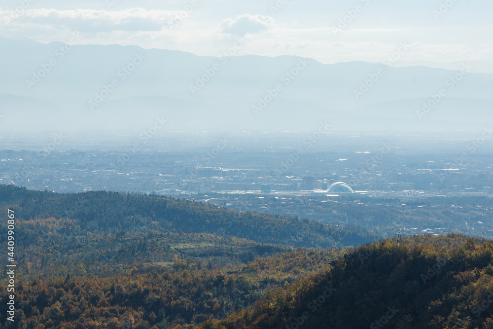 View from the mountain on the city in the valley. Haze View from the mountain on the city in the valley. Haze