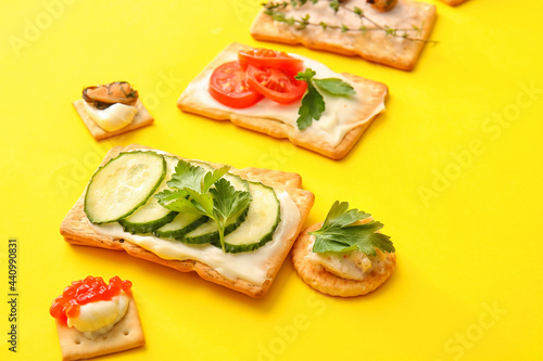 Different crackers on color background