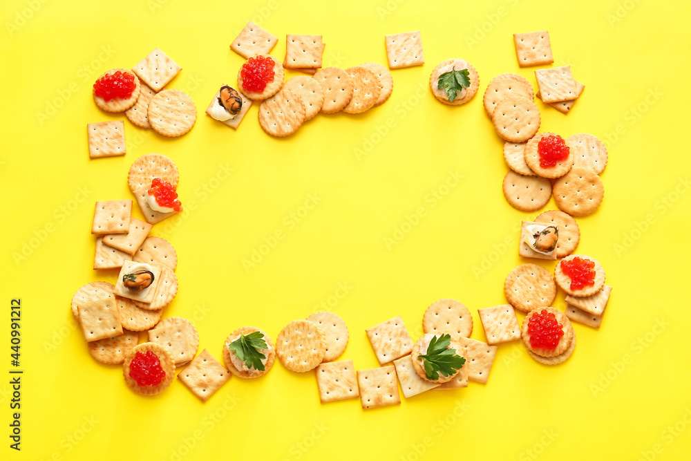 Frame made of tasty crackers on color background Frame made of tasty crackers on color background