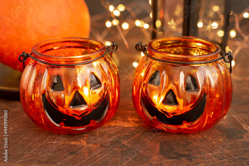 Halloween pumpkin head jack glass lantern. Halloween decoration on wooden table background, selective focus