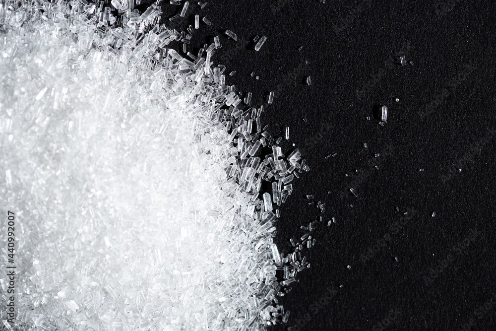 Monosodium glutamate or seasoning powder on black background and copy space. selective focus Monosodium glutamate or seasoning powder on black background and copy space. selective focus