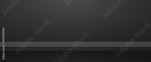 Empty shelf on a black wall. Background template. Horizontal banner